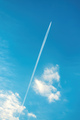 Airplane vapor trail or contrail pattern on blue sky with clouds - PhotoDune Item for Sale