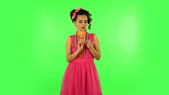 Girl Makes Herself Manicure with Pink Nail File on Green Screen at Studio