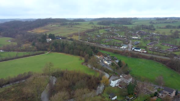 serie of 2. Drone flight over Schin op Geul, Village in the Netherlands wher a train is ariving at t