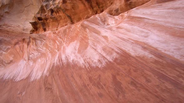 Panning view of sandstone wall in desert canyon