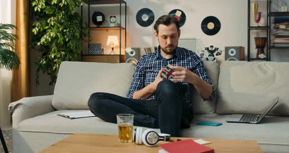 The Man is Sitting on Couch at Home Doing Homework for Extra English Classes Learning to Form