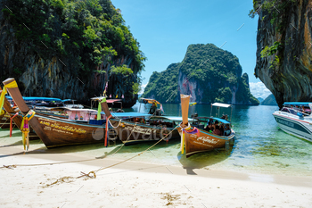 022 is a beautiful beach with longtail boats on the beach.