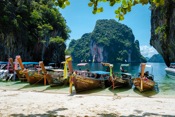 022 is a beautiful beach with longtail boats on the beach.