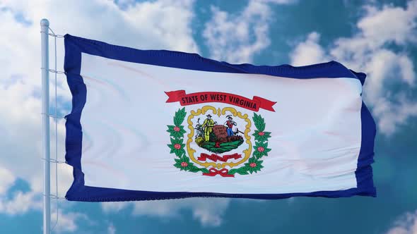 West Virginia Flag on a Flagpole Waving in the Wind Blue Sky Background