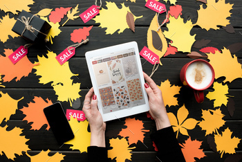 ith pinterest website on table with autumn leaves,