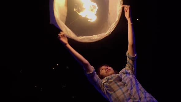 Asian Woman Releases A Sky Lantern