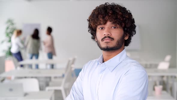 Portrait of Confident Serious Indian Ethnic Business Man Standing in Boardroom