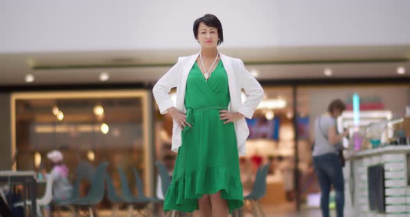 Business Brunette Woman Posing at Camera in Mall Looking at the Camera and Walking Away