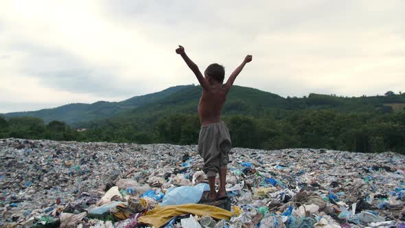 Poverty Boy Standing On Garbage Dump