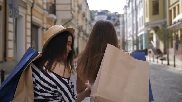 Asian and Caucasian Shopper Friends Smiling at Cam