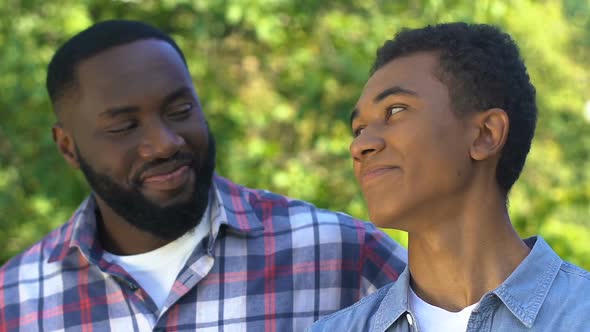 Happy Black Man Hugging Son and Scratching His Head, Happy Family, Friendship