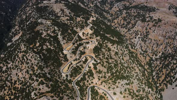 Fly above Deserted Mountain Road. Aerial view of Road in the Mountain.