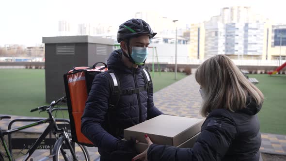 Food Courier Delivering Pizza to Customer By Bike