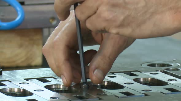 hands of engineer assembling metal parts