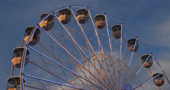 Ferris wheel in action againts a blue sky.