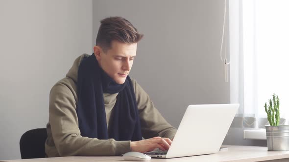 Attractive Office Worker Working Hard at His Cabinet Programming Something on His Computer