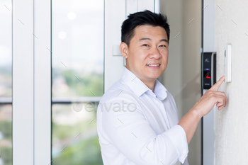 office, uses doorbell with fingerprint lock, man looks at camera and smiles
