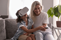 boy kid wearing virtual reality headset with his mother vr glasses in living room at home having fun - PhotoDune Item for Sale