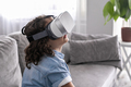 close up happy little boy child using virtual reality headset vr glasses gesturing at home fun - PhotoDune Item for Sale