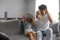 Mother and child wearing virtual reality headset vr glasses in living room at home having fun - PhotoDune Item for Sale