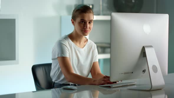 Smiling Woman Using Desktop Computer at Home Office