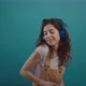 Happy Girl is Dancing and Singing in Headphones - VideoHive Item for Sale
