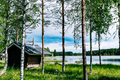 Finnish log sauna by blue lake on summer day in Finland - PhotoDune Item for Sale