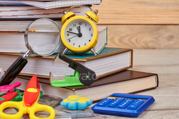 plies. Still life with books and alarm clock. Back to school concept.