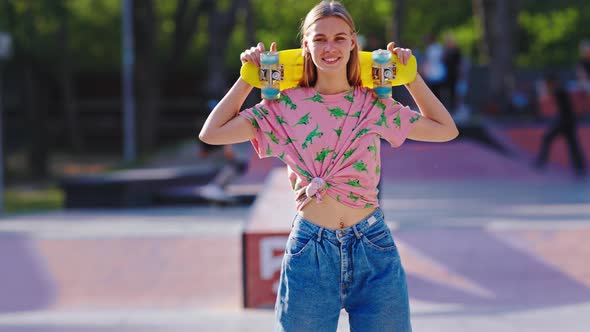 Good Looking Blonde Lady with a Skateboard on the