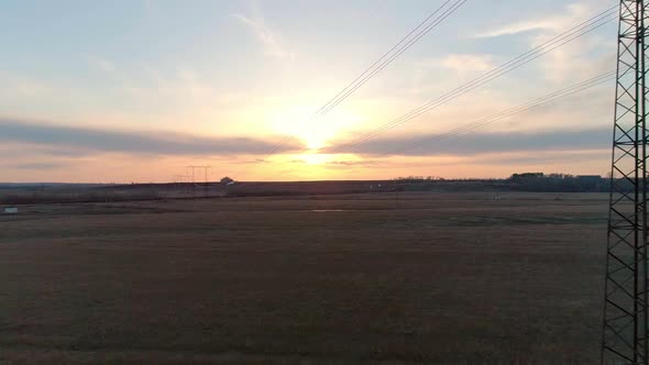 Aerial Video of the Electric Pole with Wires Against Sky at Sunset