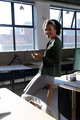 Portrait of smiling african american young businesswoman with smart phone in office - PhotoDune Item for Sale