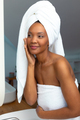 Young african american woman wrapped in towel feeling confident of her skin in bathroom, copy space - PhotoDune Item for Sale