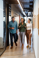 Multiracial businessman and businesswomen discussing while walking in corridor of office building - PhotoDune Item for Sale
