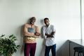 Portrait of smiling african american businessmen standing with arms crossed in creative office - PhotoDune Item for Sale