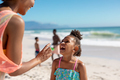 Cheerful african american mother and daughter enjoying sunny day at beach with family, copy space - PhotoDune Item for Sale