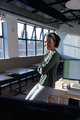 Portrait of smiling african american young businesswoman with arms crossed in office - PhotoDune Item for Sale