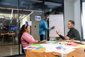 Multiracial businessman and businesswoman discussing strategy in meeting at office - PhotoDune Item for Sale