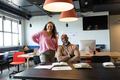 Portrait of smiling multiracial businessman and businesswoman in creative office - PhotoDune Item for Sale