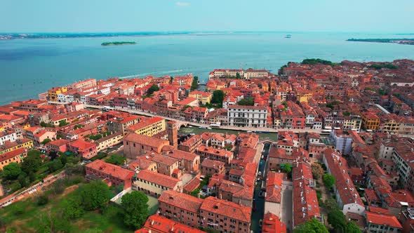 Stunning scenic view of vibrant red rooftops of Venice Italy, 4k drone.