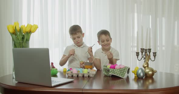 Two Boys Paint Easter Eggs and Greet Each Other