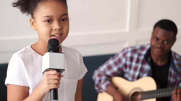 African Father Playing Guitar Daughter Singing