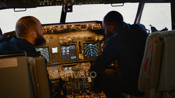 Diverse team of captain and copilot preparing to takeoff