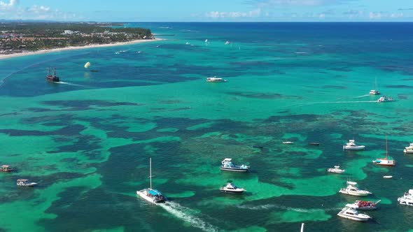 Tropical Coastline with Resorts Palm Trees and Caribbean Sea with Floating Boats and People Having