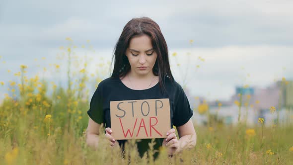 Sad Caucasian Brunette Woman Patriot Raise Placard with Inscription Stop War Unhappy Depressed Girl