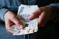 White female shows Ukrainian hryvnia bills in her hands - PhotoDune Item for Sale