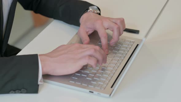 Top View of Hands of Middle Aged Businessman Typing on Laptop