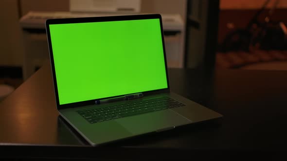 Dolly in Shot of Green Screen Laptop Indoor of Cozy Home Interior