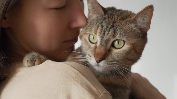 Woman Holding and Stroking a Cat