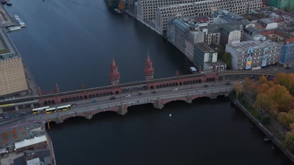 Slow Aerial Tilt Down Shot on Oberbaum Famous Bridge in Berlin, Germany with Yellow Bus and Car