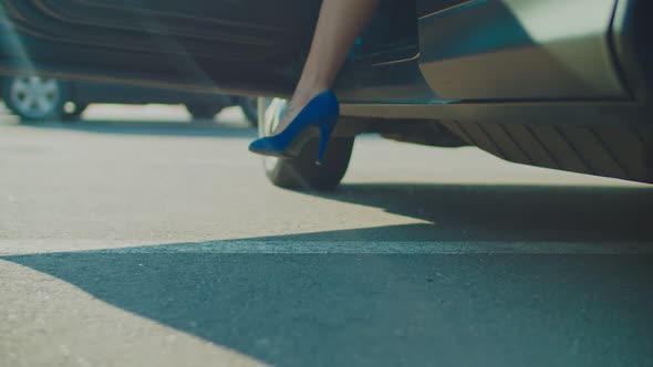 Slim Female Legs in High Heels Getting Out of Car